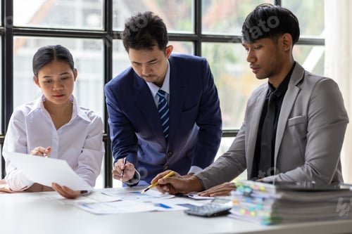 Preview: Business team having meeting analyzing financial document.
