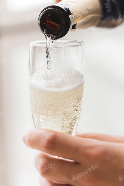 Preview: Champagne glass in hand close-up