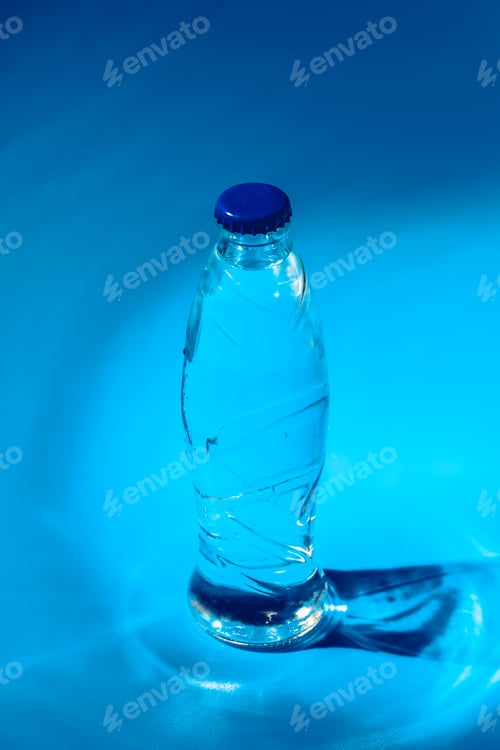 Preview: Water bottle close up on dark blue background