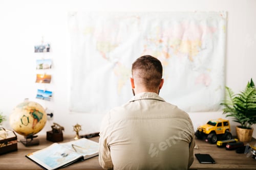 Preview: Young traveler planning his next trip from home