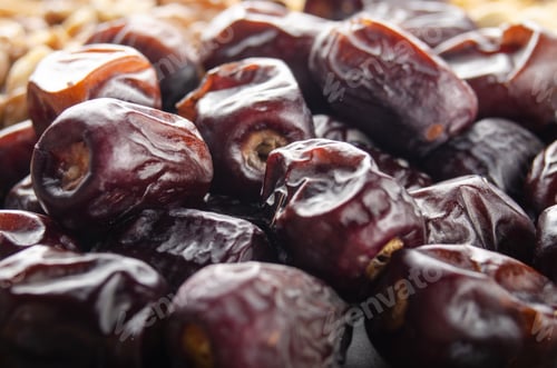 Preview: Pile of dried dates fruits on kitchen table. Healthy nutritious antioxidant natural sweeteners