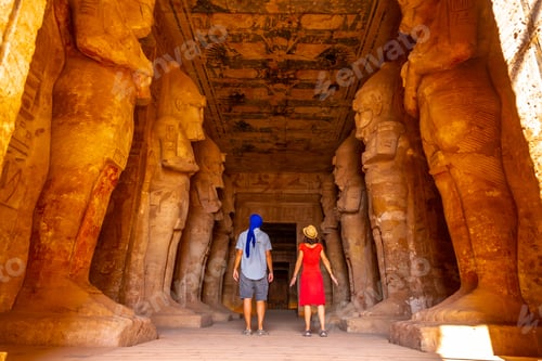 Preview: A tourist couple at the Abu Simbel Temple next to the sculptures, in southern Egypt