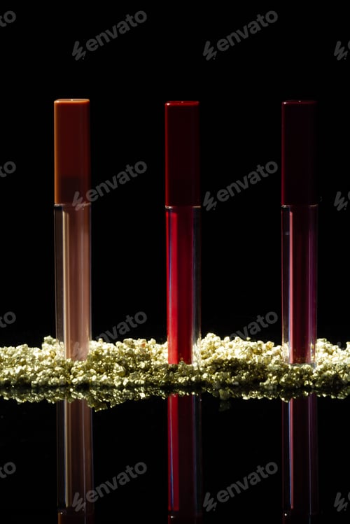 Preview: Three standing lip gloss sticks on black background.