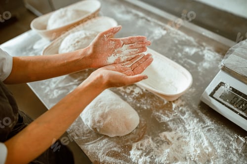 Preview: Woman shows palms covered with flour in contemporary craft bakery shop