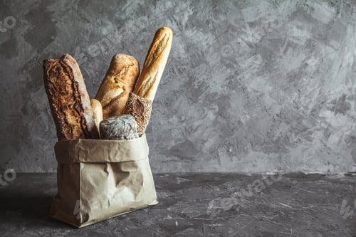 Preview: French pastries, baguettes on a gray background in a paper bag
