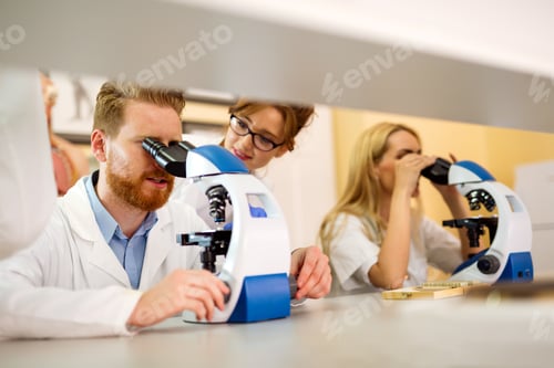 Preview: Group of medical research scientists collectively working in laboratory