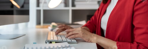 Preview: Asian businesswoman typing on a laptop computer keyboard to work on finance, taxes, reports, account