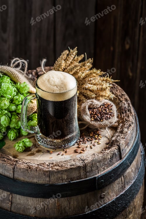 Preview: Cold pint of dark beer with ingredients, wheat and hops