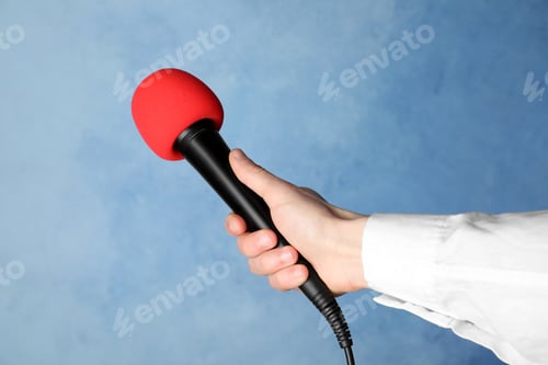 Preview: Woman holding microphone on color background, closeup