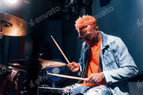 Preview: Plays drums. Young african american performer rehearsing in a recording studio