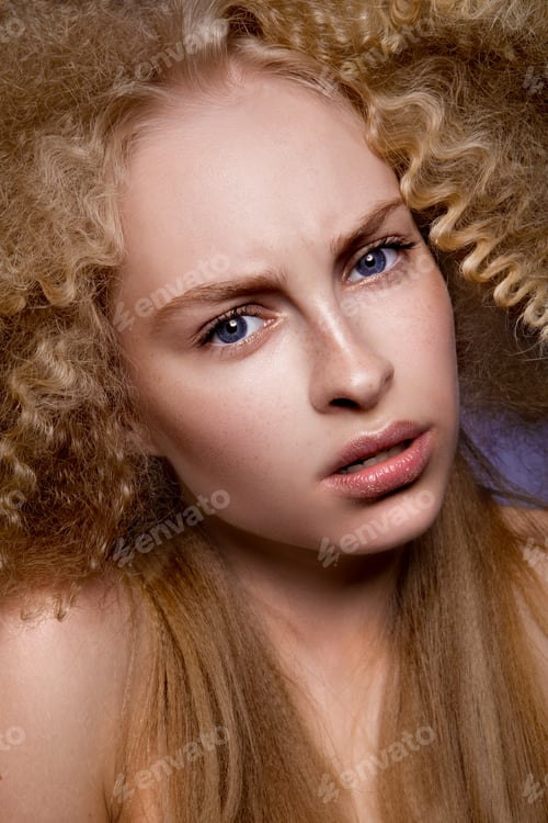 Preview: Beautiful blonde model girl with long curly hair .
