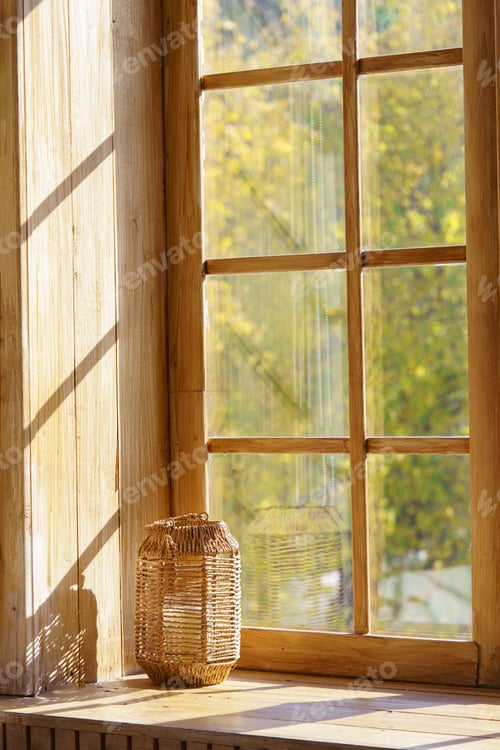 Preview: Cozy Autumn Scene With Wicker Lantern On Wooden Windowsill And Blurred Yellow Forest Background