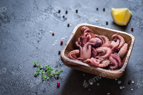 Preview: Seafood Baby octopus in a wooden bowl, copy space