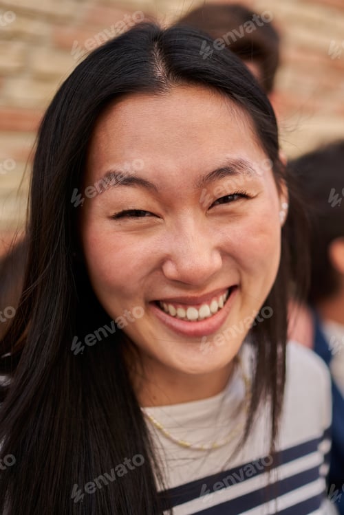 Preview: The woman smiles happily while sharing a fun moment with the group at the event outdoors.