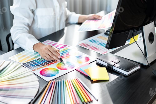 Preview: Young creative graphic designer working on color selection and drawing on graphics tablet