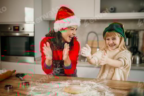 Preview: Mother and daughter baking christmas cookies sharing joy