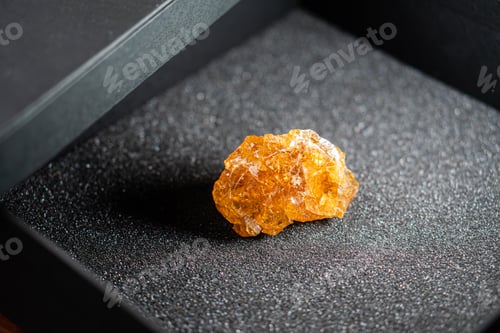 Preview: Vibrant Orange Crystal on Black Surface