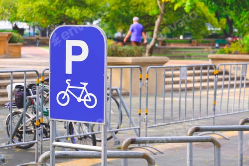 Preview: Bicycle parking sign with row of steel bicycle parking space in front of public park