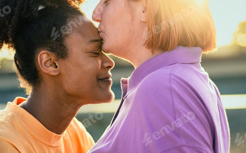 Preview: Lesbian couple having tender moments during sunset outdoor - Lgbt and love relationship concept