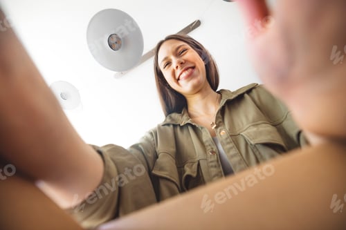 Preview: Young caucasian woman with brown hair, a customer making a purchase online from a small or large ret