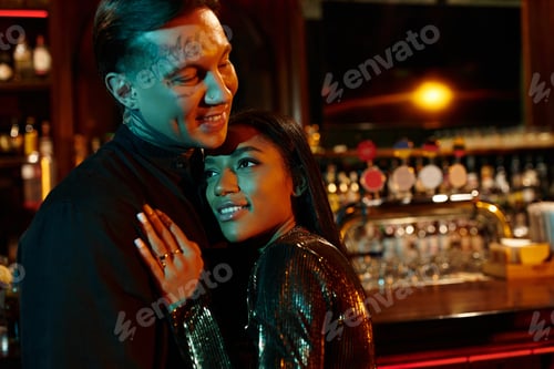 Preview: Charming multicultural couple enjoying a romantic evening at a vibrant bar