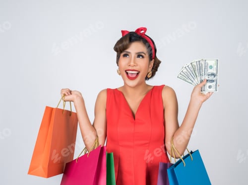 Preview: Beautiful asian woman holding colored shopping bags