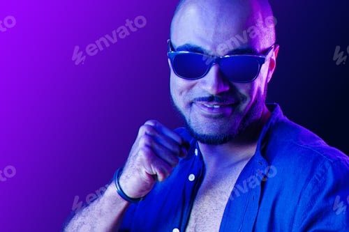 Preview: Portrait of afro american man model in glasses in neon light