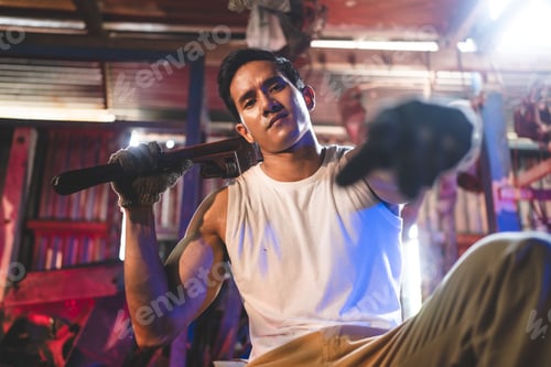 Preview: Young and handsome muscular and strop scrap material man in sleeveless shirt sitting on material