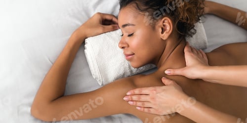 Preview: Girl enjoying shoulder massage in the health spa