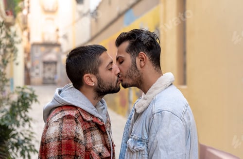 Preview: Romantic moment of a young gay couple kissing on the street