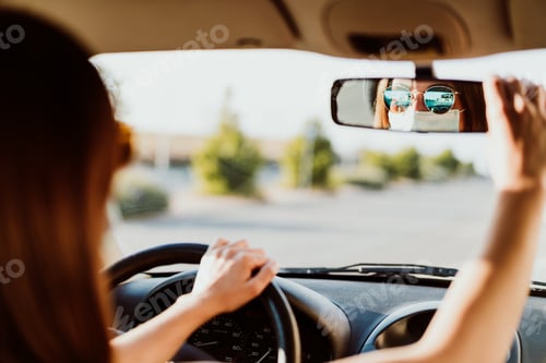 Preview: young woman in a car wearing protective mask. Summer season. prevention corona virus concept