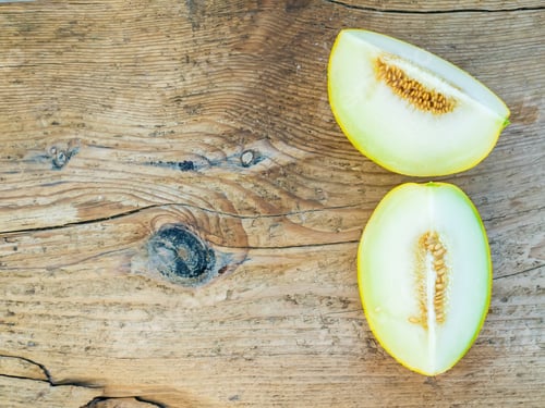 Preview: Two pieces of melon on a wooden background