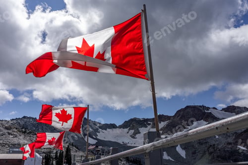 Preview: Breathtaking shot of Canadian flags flying at top of Whistler Mountain, BC, Canada