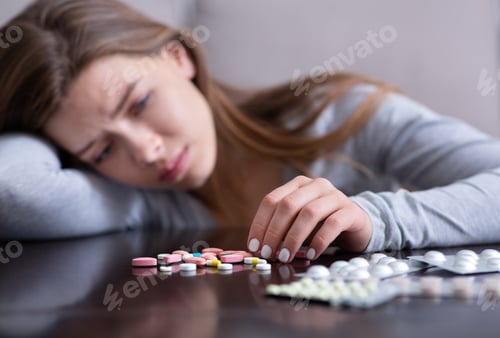 Preview: Young woman with pile of antidepressants planning to kill herself, committing suicide, suffering