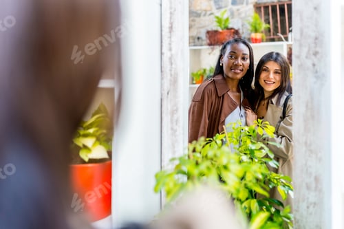 Preview: Two female friends choosing plants in a gardening store