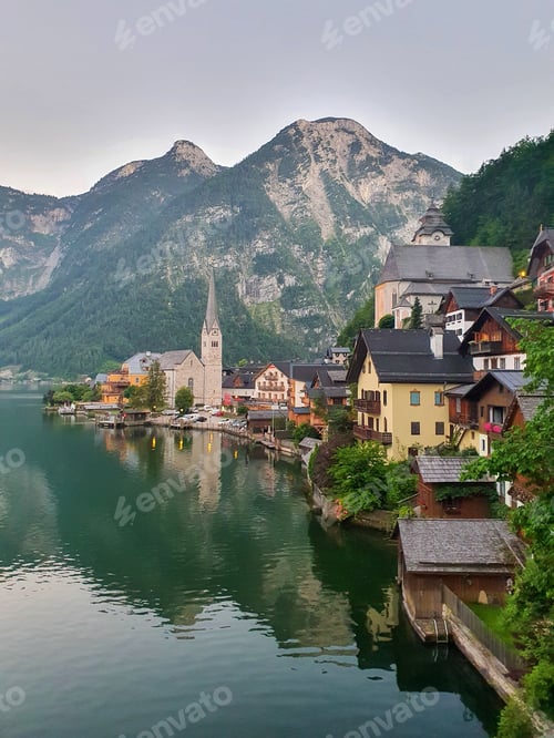Preview: Charming lakeside village nestled amid mountains at dawn in Austria's breathtaking landscape