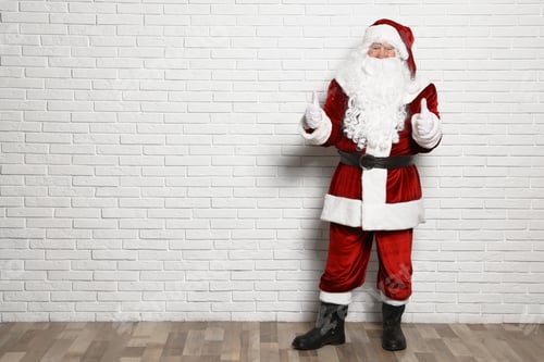 Preview: Authentic Santa Claus against white brick wall. Space for text