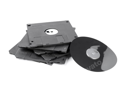 Preview: Old storage devices are stacked together with a vinyl record beside them