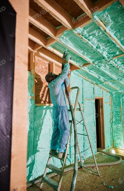 Preview: Worker spraying polyurethane foam for insulating wooden frame house.
