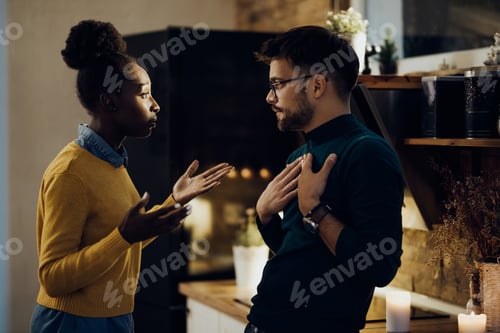 Preview: Young couple with relationship difficulties arguing at home.