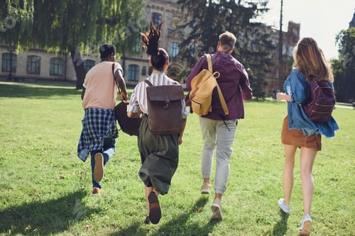 Preview: back view of happy multicultural students running to college in park
