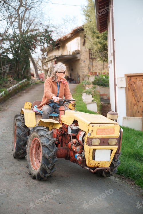 Preview: Woman Drives a Yellow Tractor on Country Road