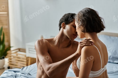 Preview: Intimate embrace on a sunlit bed