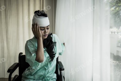 Preview: Female patients having pain in her head after hospitalization in patient's room hospital.