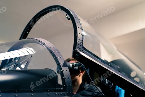 Preview: boy sitting in flight simulator military plane wearing virtual reality glasses flight entertainment