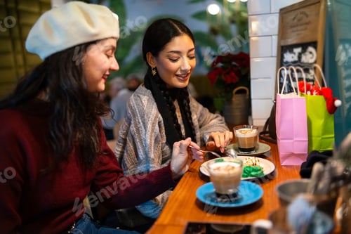 Preview: Friends exchanging christmas gifts and sharing coffee