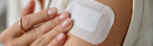 Preview: Woman Touching Arm after Applying Medical Patch