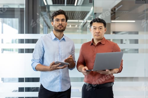 Preview: Two professionals collaborating with technology in a modern office