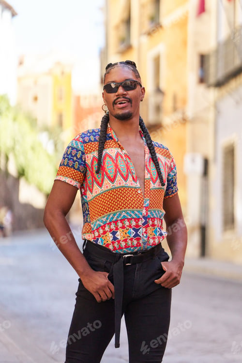 Preview: Stylish androgynous man posing in urban setting with colorful shirt