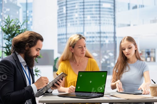 Preview: Financial advisor using green screen laptop to help clients manage portfolio